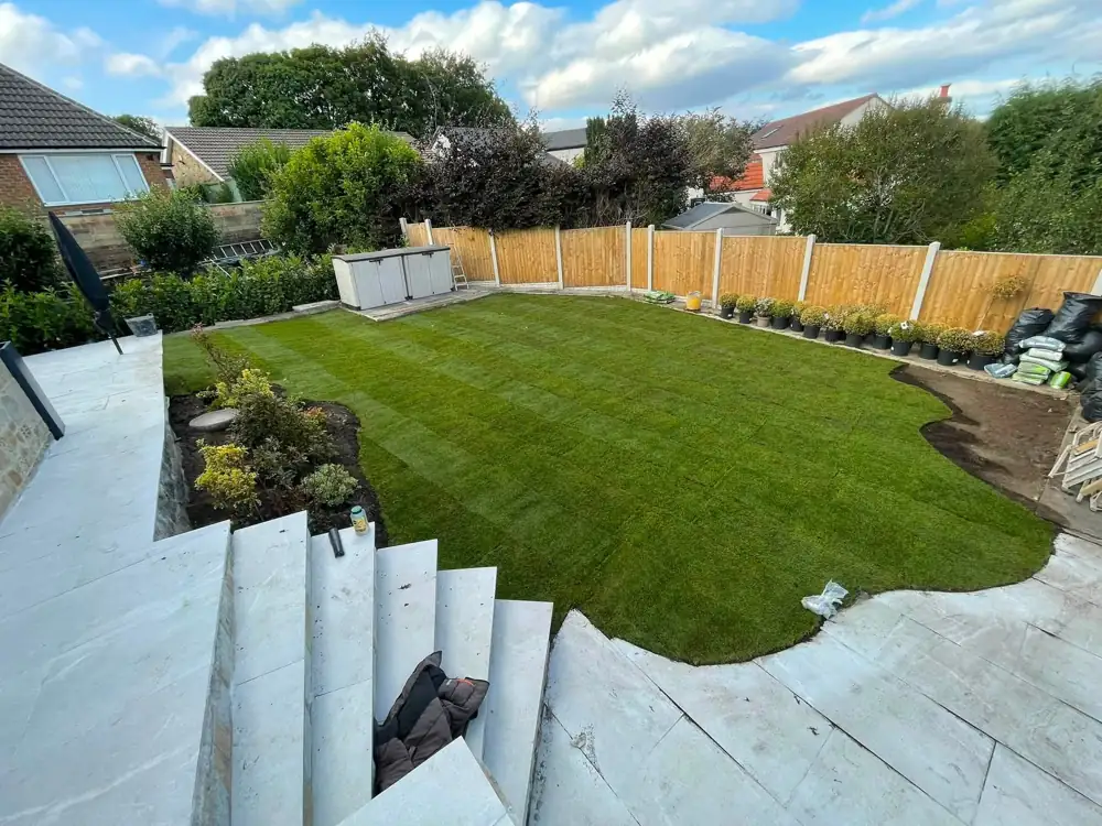 After: new turf lawn with patio and fencing